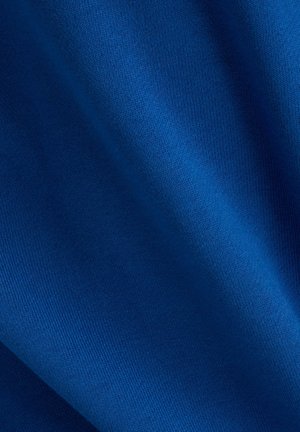Bright blue fabric with a smooth, slightly textured surface, displaying folds that indicate flexibility and softness. No patterns or accents visible.