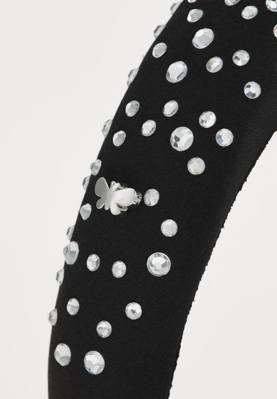Black headband adorned with clear rhinestones and a small silver butterfly accent. Textured fabric with a smooth finish.