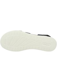 Biała gumowa podeszwa z teksturowanym wzorem, z rowkami i wypustkami zapewniającymi przyczepność. Czarne paski nakładają się na wkładkę, tworząc minimalistyczny design.