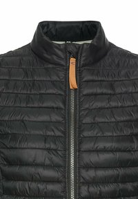 Black insulated jacket featuring a high collar, horizontal quilted texture, and a contrasting zipper with an orange pull tab.