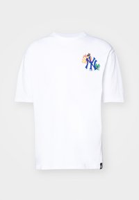 Camiseta de algodón blanca con un logo azul de NY y bordado floral en rosa, amarillo y verde. Mangas cortas y cuello redondo.