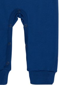 Navyblauer Overall aus Baumwollstoff, mit langen Ärmeln, Druckknopfverschluss unten und gerippten Bündchen für einen enganliegenden Sitz.