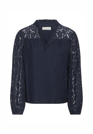 Tumši zilas blūzes ar gariem mežģīņu piedurknēm, V veida izgriezumu un teksturētu audumu, ar ziedu mežģīņu rakstu plecos un piedurknēs.