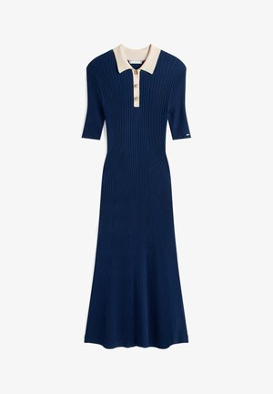 Navy ribbed dress with short sleeves, a cream collar, and three button details running down the front. Flared bottom hem.