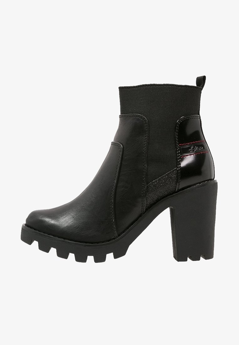 Black ankle boots with a chunky heel, featuring smooth and textured leather, elastic fabric upper, and subtle red accent stitching.