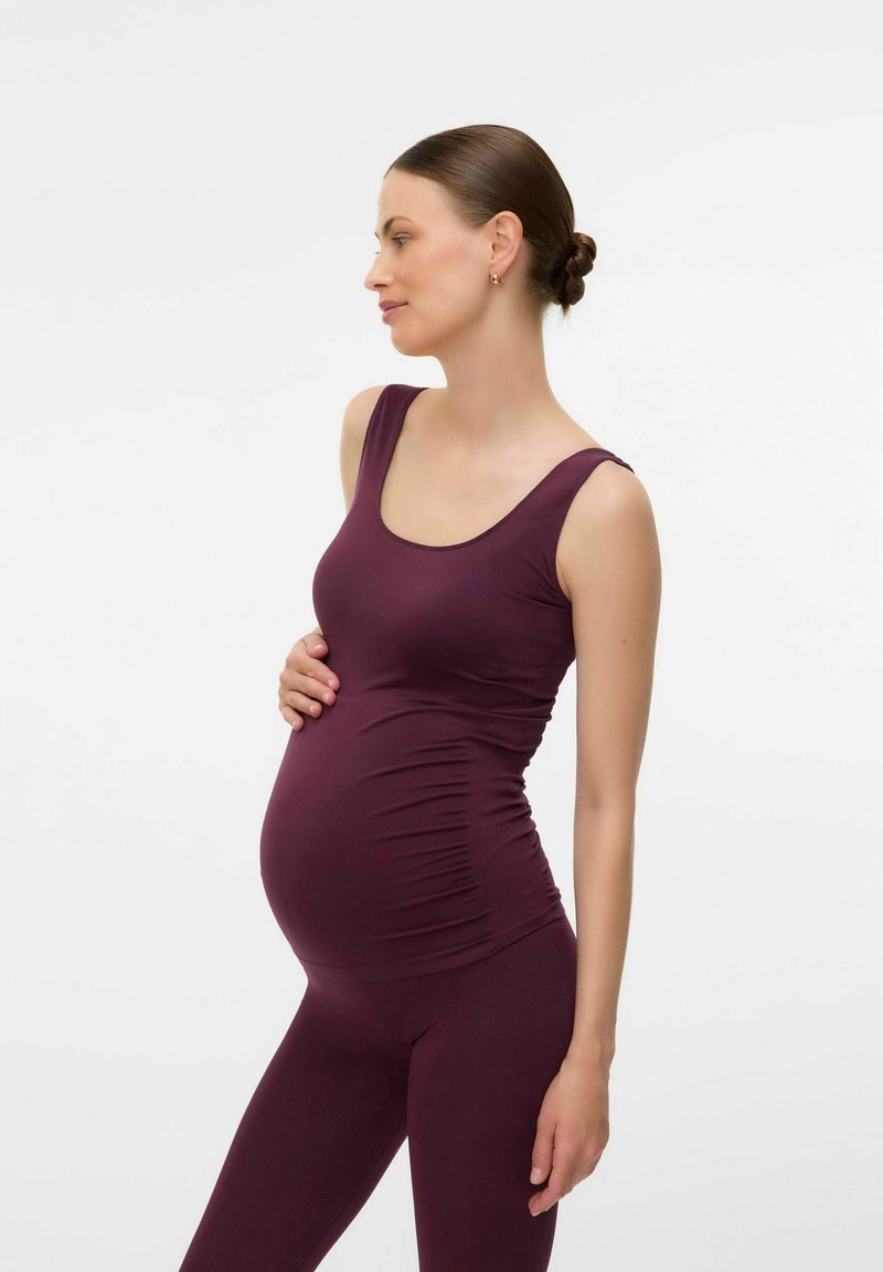 Graviditetstopp och leggings i djup bourgogne, med mjukt,Stretchigt tyg och samling vid magen för en bekväm passform.
