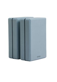 Deux blocs de yoga de couleur bleu clair en mousse, présentant une forme rectangulaire élégante avec des bords angulés et des accents de rayures noires sur les côtés.