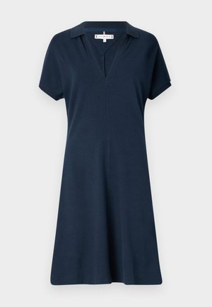 Navy blue short-sleeve dress in soft fabric with a polo collar, V-neck, and a flared silhouette, featuring a subtle seam detail at the chest.