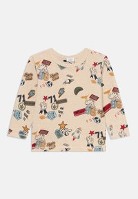 Beige long-sleeve t-shirt featuring various colorful graphic prints, including dinosaurs, planets, and badges, against a soft cotton fabric.