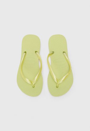 Pereche de papuci flip-flop din cauciuc verde deschis, cu tălpi texturate și barete lucioase în formă de Y, pe un fundal simplu și luminos.