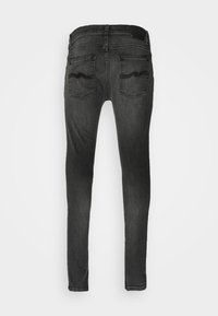 Smalpassade svarta jeans i denim med midjehöjd, fem fickor och subtil vågmönstrad söm på bakfickorna.