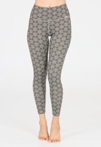 Grijze legging met een hoog tailleband, voorzien van een bloemenpatroon in donkere tinten. Gemaakt van een rekbaar materiaal voor extra comfort.