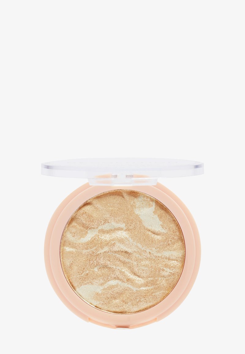Enlumineur marbré or et crème dans un boîtier rond avec un couvercle transparent, doté d'une texture lisse et d'un étui doux de couleur pêche.