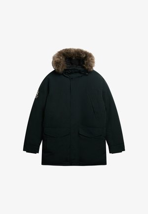 Zwarte parka jas met een met bont gevoerde capuchon, twee zijzakken en een ritssluiting. Bevat een gestructureerd oppervlak en verstelbare trekkoorden.