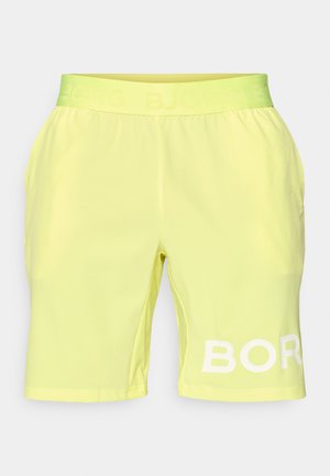 Yellow athletic shorts with a soft texture, elastic waistband, and "BJÖRG" logo printed in white on the left leg.