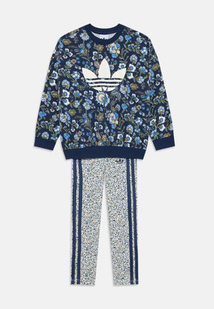 Floral-patterned sweatshirt in navy with white Adidas logo; matching trousers with small floral print and navy side stripes.