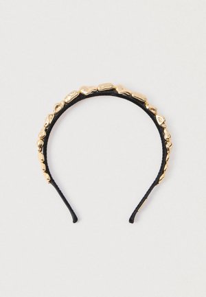 Bentită neagră din material textil decorată cu mărgele metalice aurii neregulate și lucioase de-a lungul marginii superioare, pe un fundal deschis.