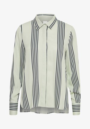 Heleda helesinine nööpidega särk, millel on tumesinised vertikaalsed triibud, krae, pikad varrukad ja ümar äär. Siledast kangast, veidi vabalt istuv.