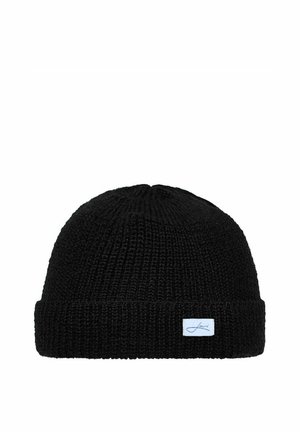Black knitted beanie hat with a folded cuff and a small white rectangular label sewn onto the cuff.