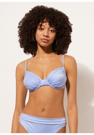 Ljusblå bikini med en samlad, tvistdesign på toppen och justerbara band; botten har en rynkad midja. Mjuk, slät textur.