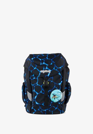 Schwarz-blauer Rucksack mit Muster, vorne Schnalle, Seitentaschen, Reflektorflächen und einem runden Abzeichen mit Haifischmotiv.