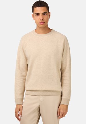 Beige sweatshirt med rund hals og raglanærmer samt ribbet manchetter. Blød tekstur, minimalistisk design og ingen synlige mønstre eller dekorative detaljer.