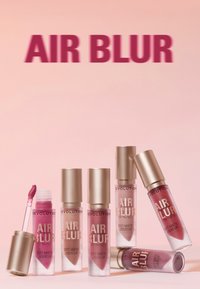 Revolution Air Blur flytende leppestiftprodukter viser myke matte finish i forskjellige nyanser av rosa, pakket i klare rør med gullfargede hetter.