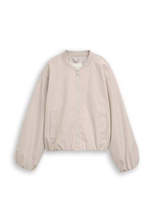 Veste beige clair zippée avec poignets et ourlet élastiques, deux poches devant et encolure ronde sur fond blanc.
