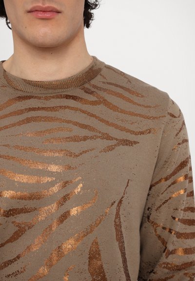 Brown knit sweater featuring a textured tiger stripe pattern in metallic rose gold, with a round neck and ribbed trim.