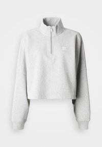Jasnoszary krótki sweatshirt z wysokim kołnierzem i półzamkiem. Posiada luźne rękawy oraz małe białe logo na piersi. Materiał mieszany z bawełną.