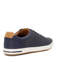 Navy blue leather sneaker with beige back accent, white sole, and lace-up design. Features subtle perforations for breathability.