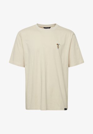 Cream cotton t-shirt with short sleeves, crew neck, and left chest embroidery of a character holding a golf club.