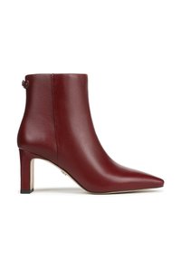 Stivaletto alla caviglia in pelle bordeaux con punta a spillo e tacco di 7,5 cm. Presenta una fascia laterale con dettaglio fibbia e una texture liscia.