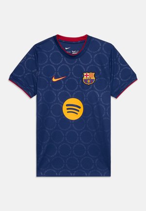Maillot de football bleu du FC Barcelone avec logos orange Nike et Spotify, écusson du club, col et bords de manches rouges.