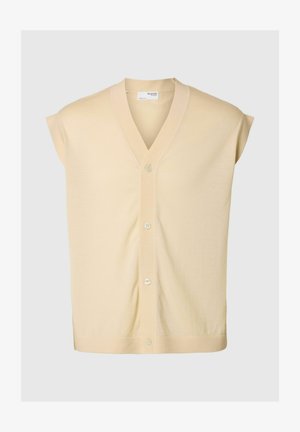 Īsām piedurknēm, V-veida kakla izgriezuma kardigāns mīkstā bēša adījumā, ar pogu priekšpusi un brīvu piegriezumu. Nav rakstu vai rotājumu.