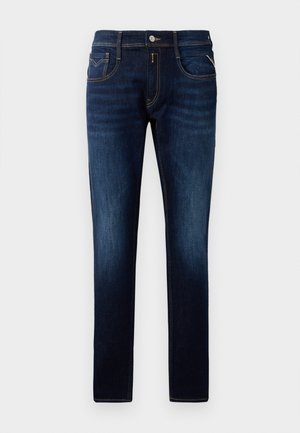 Dunkelblaue Denim-Jeans mit Slim Fit, mit kontrastierenden Nähten, Knopfverschluss und Fünf-Taschen-Design. Glatte Textur, minimale Ausbleichung.