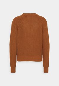 Pull tricoté couleur rouille avec un motif côtelé, col rond et manches longues. L'ourlet est légèrement raccourci pour une coupe décontractée.