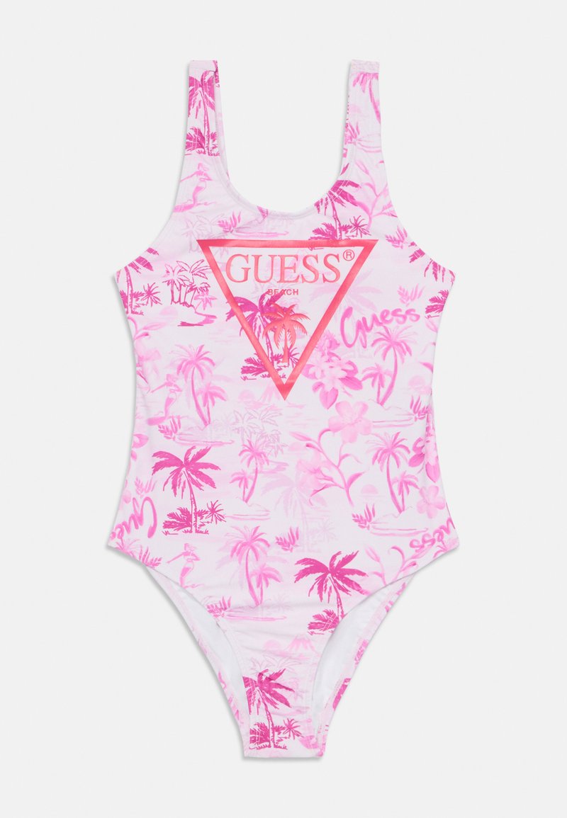 En delad baddräkt i rosa och vitt, med ett tropiskt palmträdsmönster, en triangelformad Guess-logotyp och breda axelband.