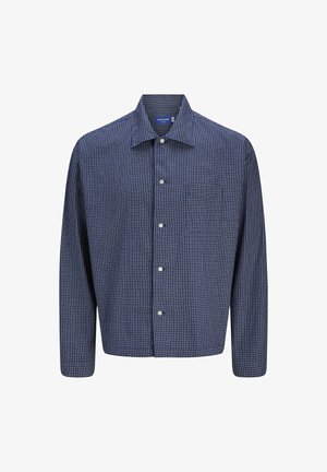 Tumesinine ja valge ruuduline särk, pikad varrukad, nööpidega ees, klassikaline krae ja üks rinnaTasku. Puuvillane kangas, struktureeritud kuju.