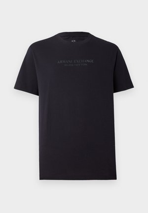 Black cotton t-shirt with short sleeves, round neck, and a slightly relaxed fit. Features "ARMANI EXCHANGE MILANO / NEW YORK" in dark gray text.