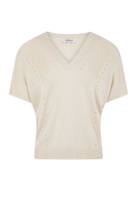 Beige kortärmad stickad tröja med V-ringning, ribbade muddar och nederkant, samt dekorativa små hål längs axlarna och sidorna.