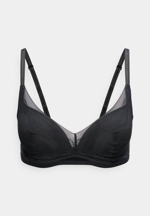 Soutien-gorge en tulle noir transparent avec bretelles fines réglables et armatures, présentant un délicat motif à pois et des bords subtilement festonnés.