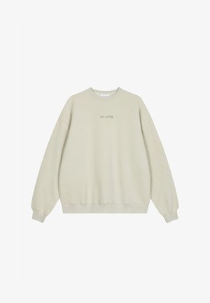 Gai bēšs sporta krekls ar apaļu kaklu, ribota piedurkņu un apakšmalas, ar vārdiem "OH APRIL" izšūti atbilstošā krāsā vidū.