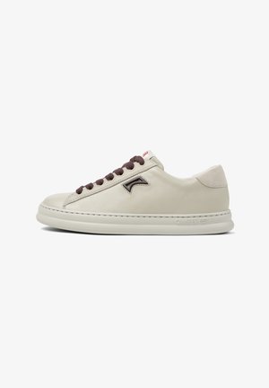 Cream leather sneaker with brown laces, round toe, textured panel, and raised logo detail. White sole with subtle branding.