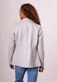 Light gray leather jacket with a fitted waist and long sleeves, featuring back yoke detail and seams for structured design.