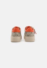 Sneakers with a patterned beige upper, orange heel accents, and a cream-colored sole. Features a sleek, low-top design.