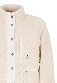Veste polaire sherpa couleur crème avec boutons-pression, poches zippées sur la poitrine et les côtés, et un col montant.