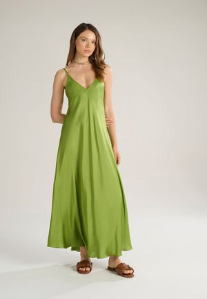 Green, satin maxi dress with a V-neckline and adjustable spaghetti straps. Flowing, smooth texture; minimalist design with a relaxed fit.