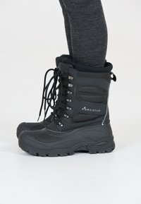 Stivali invernali neri con una parte superiore testurizzata, chiusura con lacci, collo imbottito e suola robusta per un'ottima aderenza. Presentano il marchio Whistler di lato.