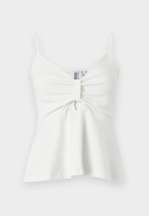 Camisole blanche sans manches avec fines bretelles, devant central froncé avec détail en boucle de tissu et ourlet légèrement évasé.